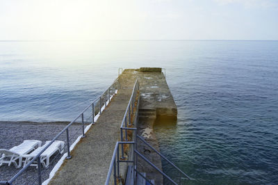 Empty sun loungers by the sea early in the morning, calm, sunrise.