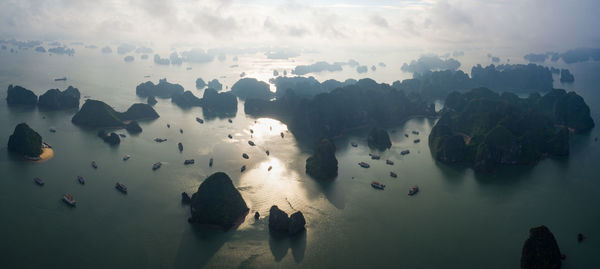 Aerial view of rock formation in sea against sky