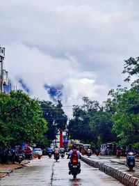 Cars on road in city against sky