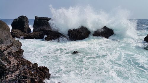 Waves splashing on rocks at beach