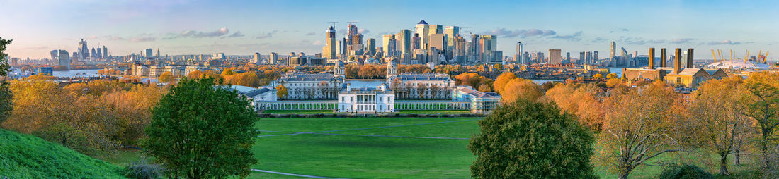 Panoramic view of trees and buildings against sky