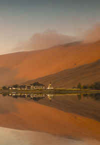 Scenic view of lake against sky during sunset