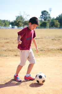 Boy playing soccer on field