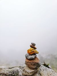 Close-up of stone stacked during foggy weather