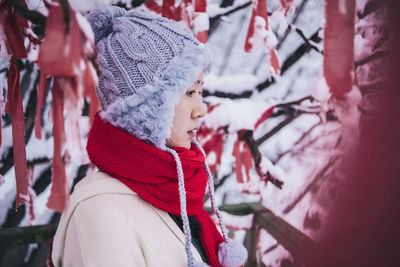 Side view of thoughtful woman in snow