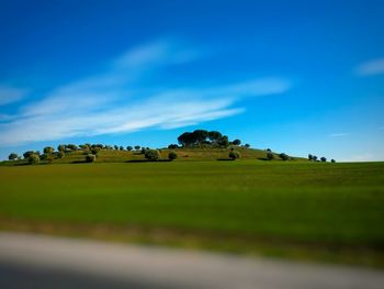 Scenic view of field against cloudy sky