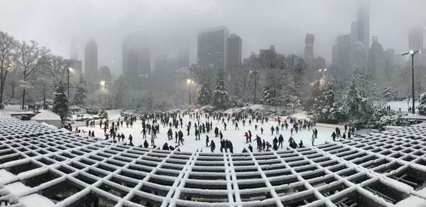 Panoramic view of people in city during winter