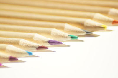 Color pencils arranged on white background