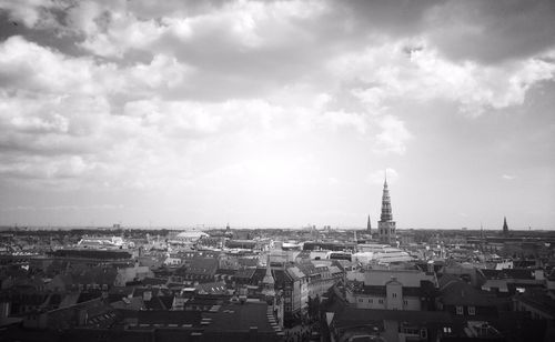 View of cityscape against cloudy sky