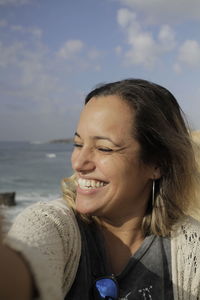 Close-up of smiling woman at beach