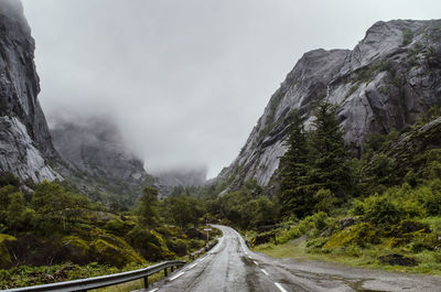 Road amidst mountains against sky