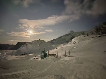 Scenic view of snow covered mountains against sky