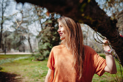 Woman with long hair standing at park