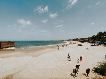 People on beach against sky