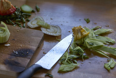 Close-up of knife and leftovers on cutting board