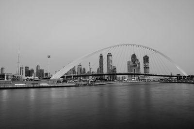 View of suspension bridge with city in background