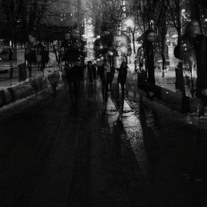 People walking in city at night