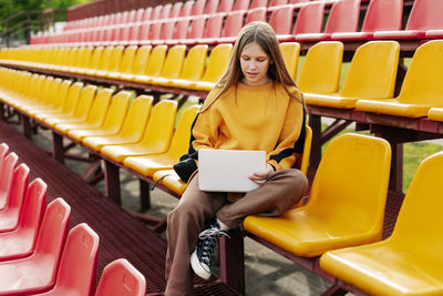 Portrait of young woman sitting on chair