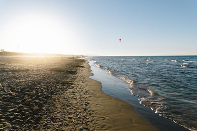 Beautiful summer afternoon on the beach with the sun on the horizon in mediterranean sea, oliva