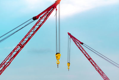 Crawler crane against blue sky and white clouds. real estate industry. red crawler crane.