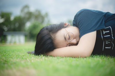 Low section of young woman lying down on land