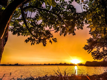 Scenic view of lake against sky during sunset