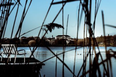 Sailboats in lake against clear sky
