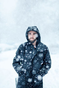 Young man standing in snow