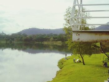 Scenic view of lake against cloudy sky