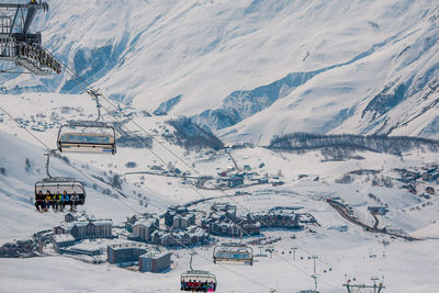 Aerial view of people skiing on snow covered landscape