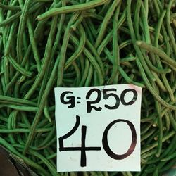 Close-up of price tag on green beans at market