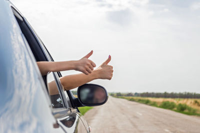 Rear view of woman holding car