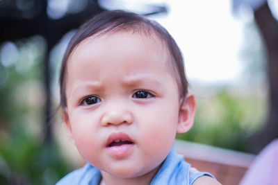 Portrait of cute baby boy looking away