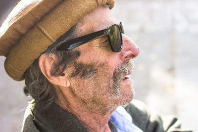 Portrait of man with arms raised looking away