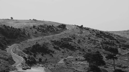 Scenic view of road by landscape against clear sky