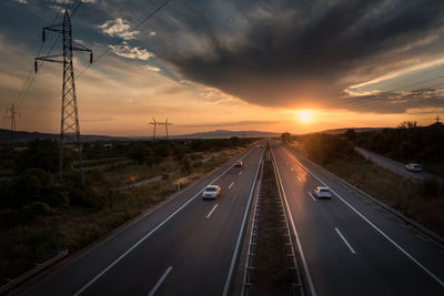 High angle view of cars on road against sky during sunset