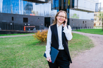 Successful businesswoman or manager, woman talking on mobile phone while