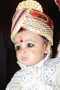 Close-up of cute boy looking away