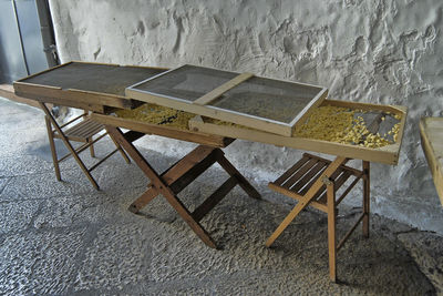 High angle view of empty chairs and table on floor against wall