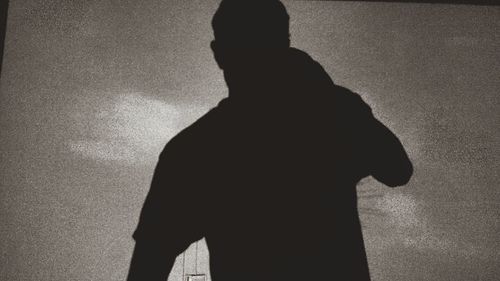 Silhouette of man standing on floor