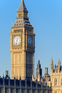 Low angle view of clock tower against sky in city