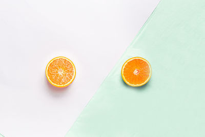 High angle view of orange fruit against white background