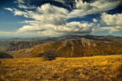 Scenic view of landscape against cloudy sky