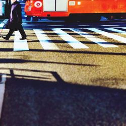 Shadow of man on road