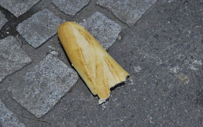 High angle view of yellow leaf on footpath