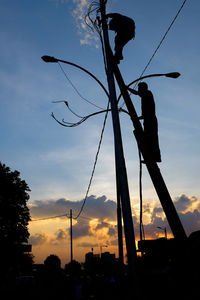 Low angle view of silhouette trees against sky at sunset