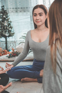 Portrait of a smiling young woman sitting outdoors