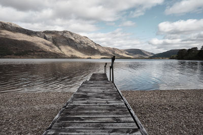 Pier over lake against sky