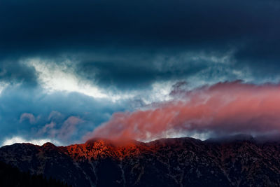 Scenic view of mountains against dramatic sky