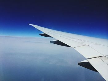 Cropped image of airplane flying in sky